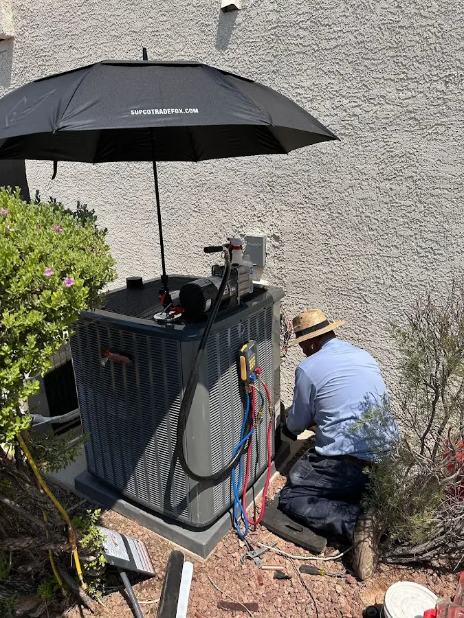 HVAC technician performing outdoor AC maintenance in Lake Alfred